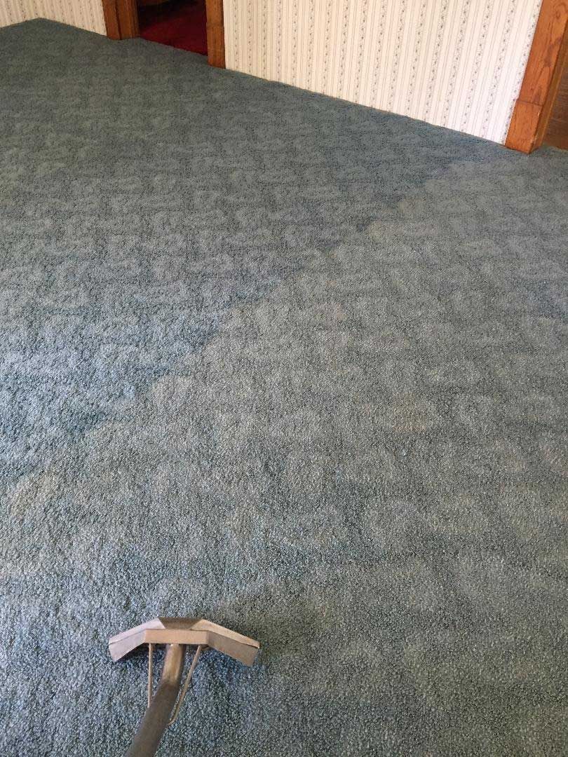 Patterned carpet being cleaned with an extraction wand