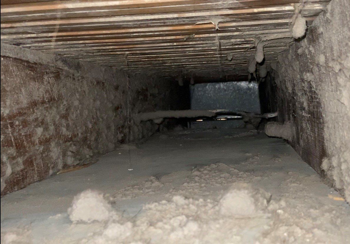 Close-up of a dusty air duct before cleaning